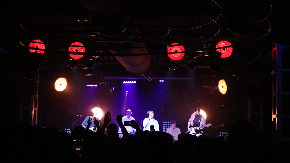 Concert stage and crowd in atmospheric lighting